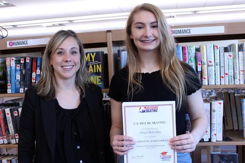 a girl holding a certificate