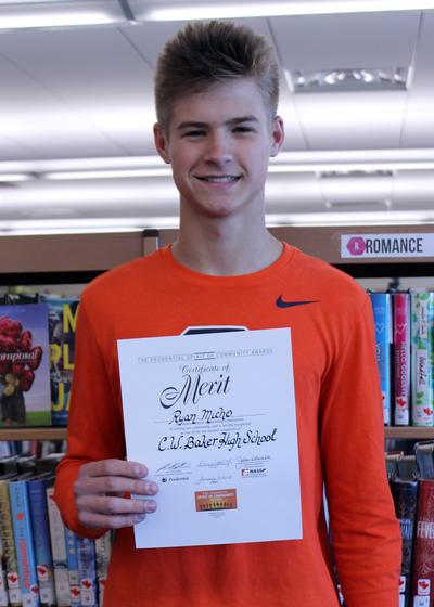 a boy holding a certificate