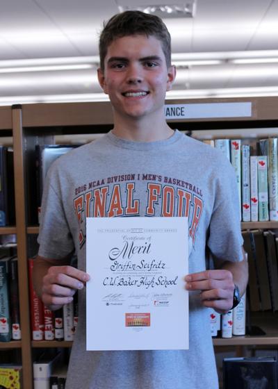 a boy holding a certificate