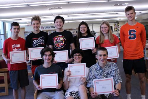 boys holding certificates