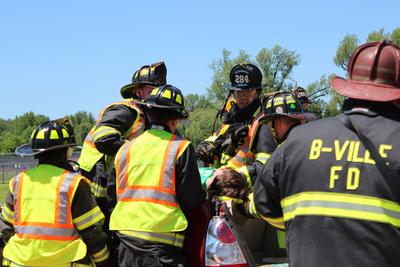 emergency responders take body out of car