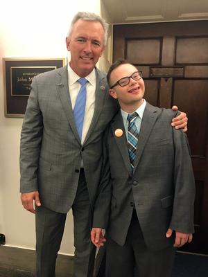 an older man in a suit with a  younger man in a suit