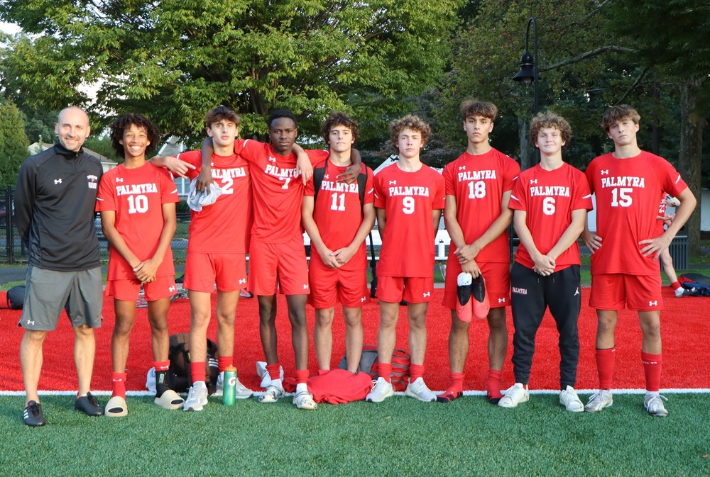 coach mike pap with his 8 senior boys in uniform at Legion Field
