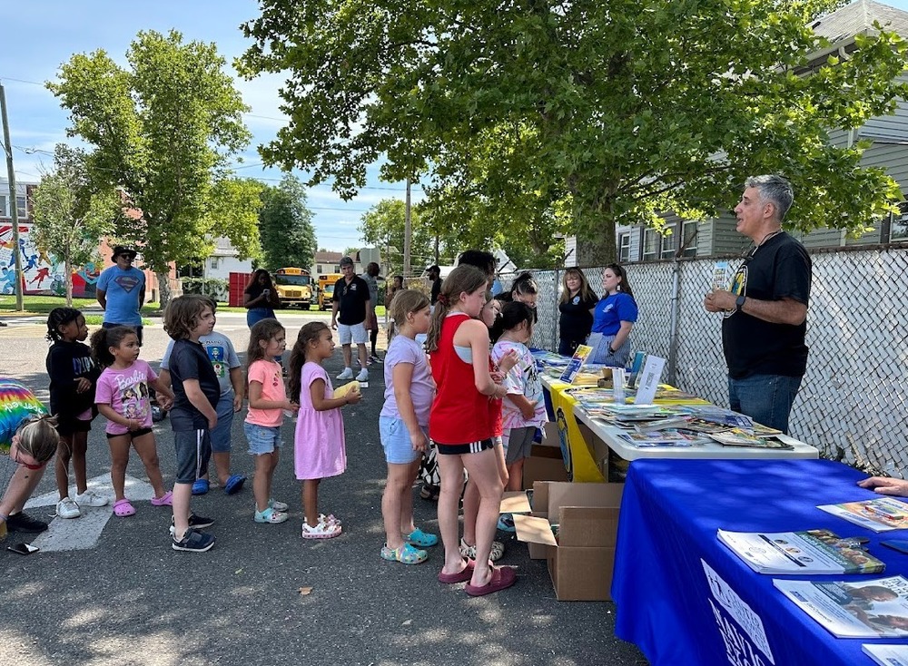 summer camp students are treated to a free book from Book Smiles in the Parking lot at PHS