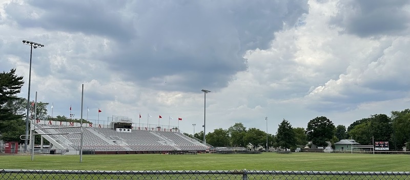 photo of the high school stadium with dark clouds all set up for outdoor graduation