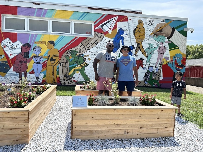 Senator Singleton & Supt Mark Pease in front of the BeKind Mural & the Class of 2024 gardens- mini-intendent is looking on