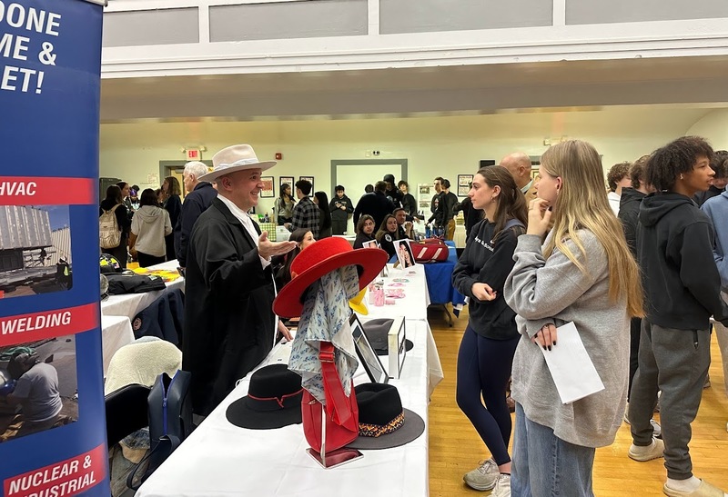 students listening to a vendor at career fair