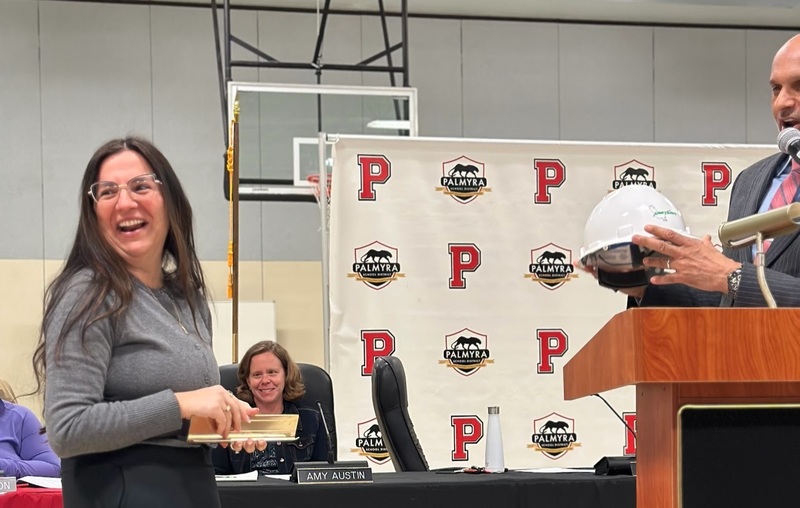 hard hat being presented to Dr. Norton