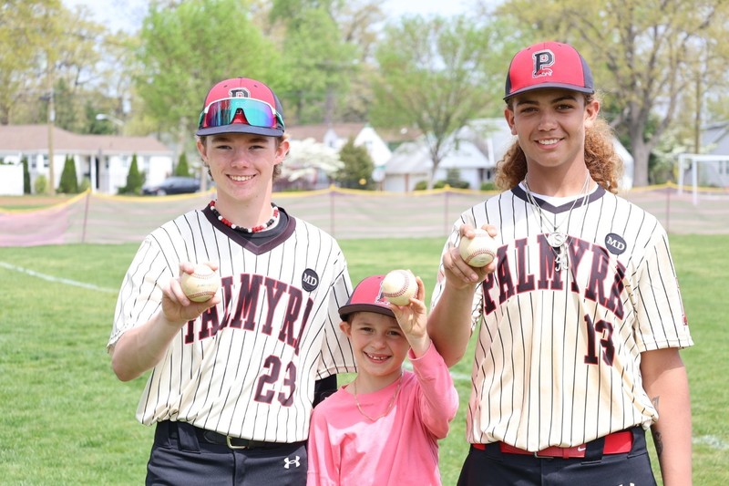 2 baseball players & a fan holding baseballs at CSS field