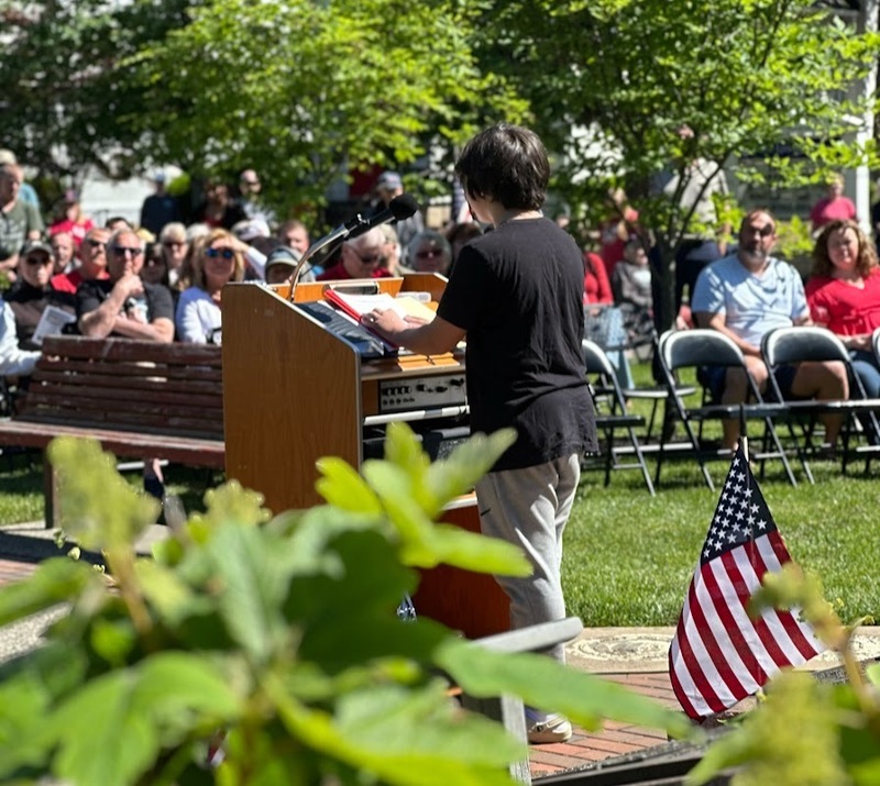 Benjamin Dickinson reads his essay on Memorial Day aloud to the Memorial Day assembly in the park