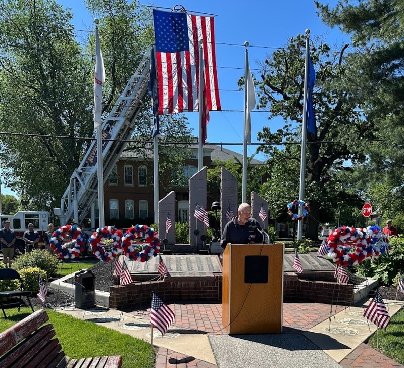 With Independence Fire Company holding the Flag high above from their ladder, the Memorial Day ceremony comes to a close while Taps are played