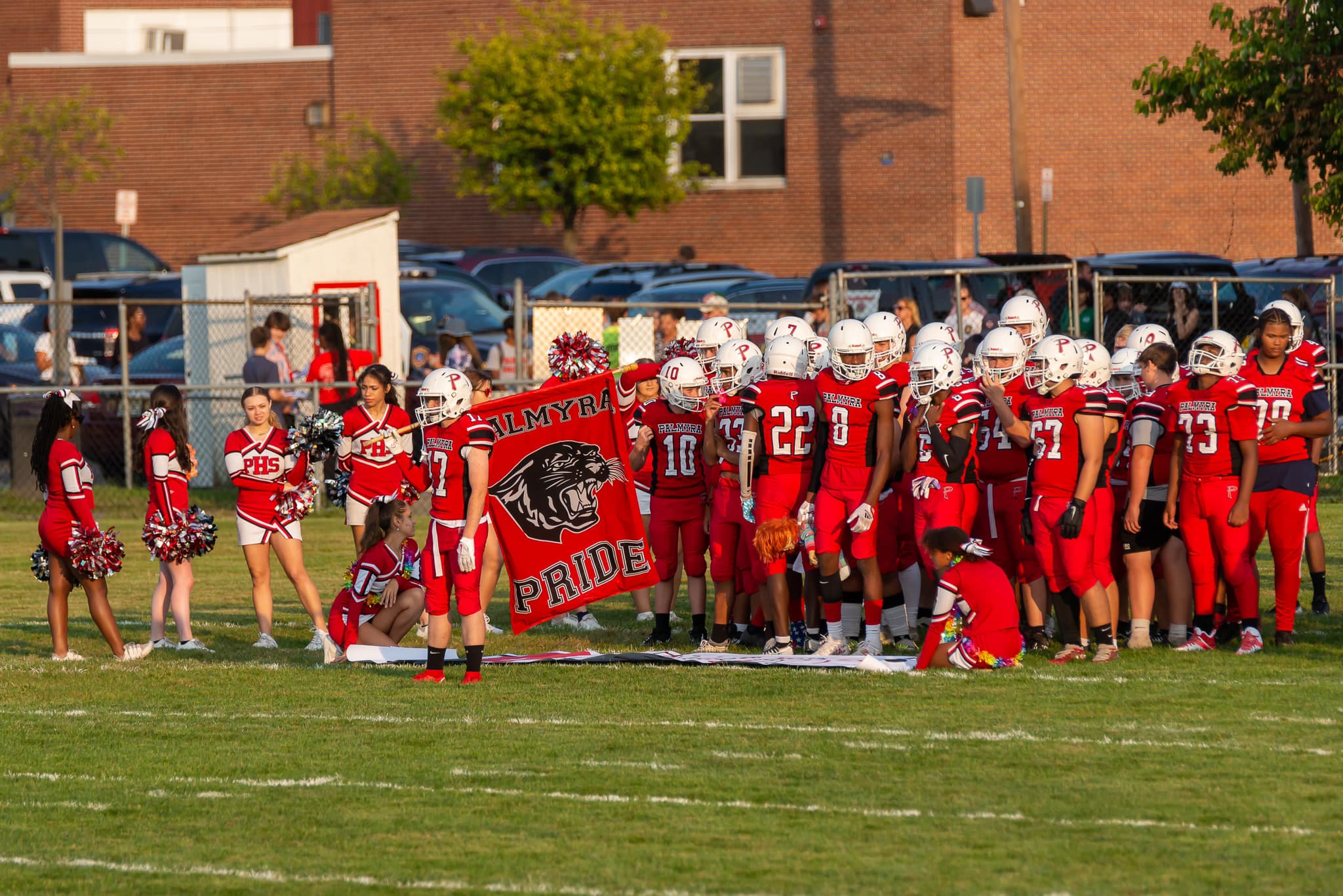 palmyra football players and cheerleaders on the field