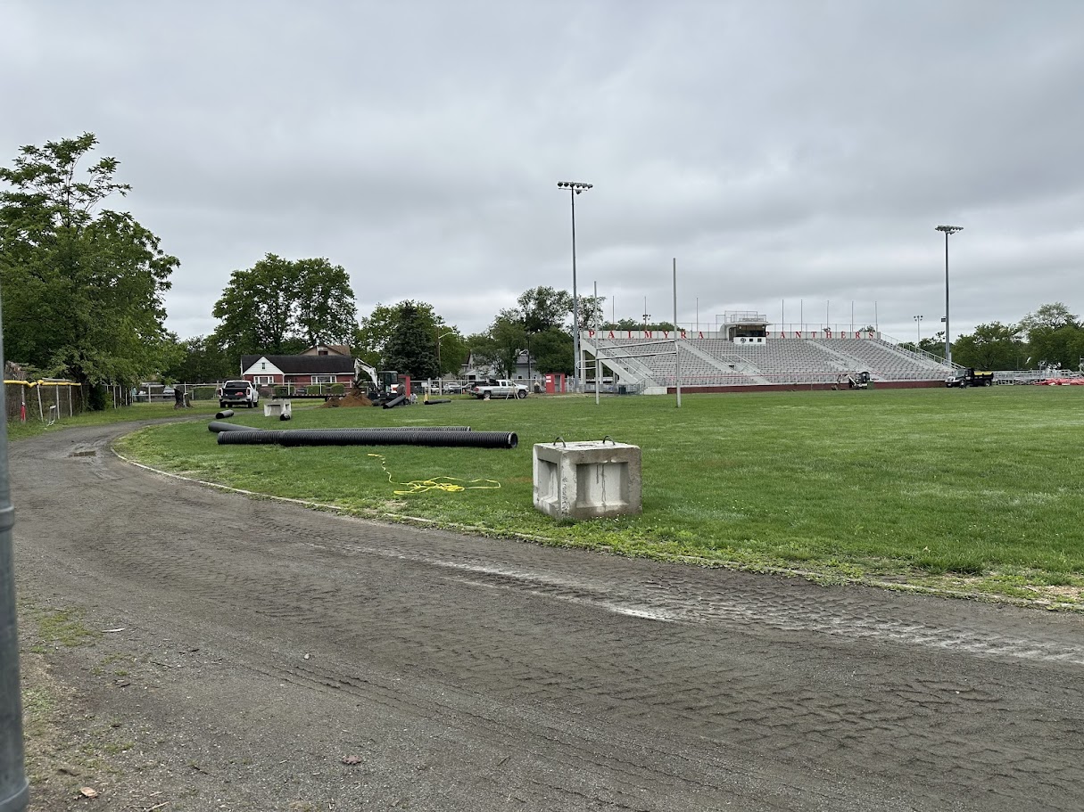 Stadium track drainage being worked on with trucks & tubes
