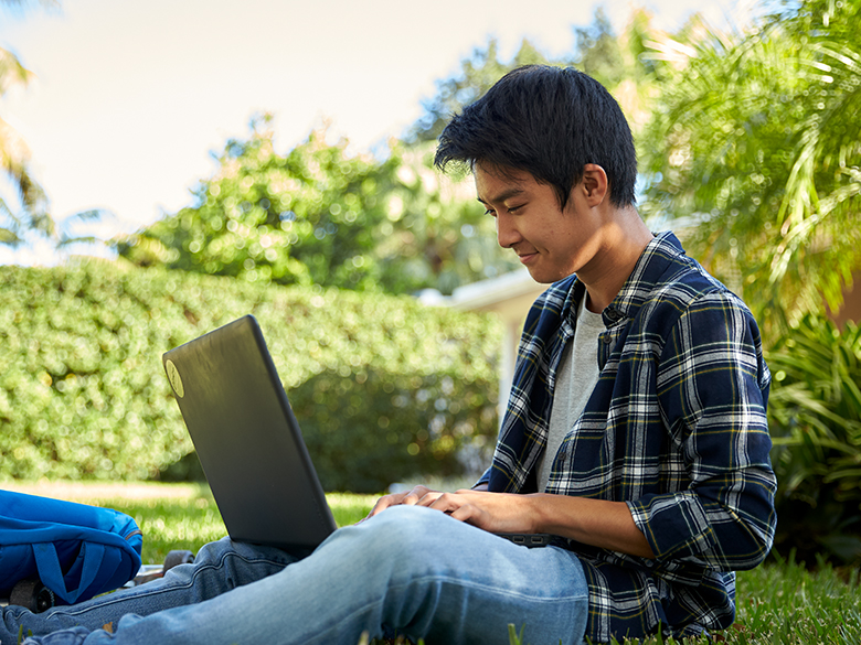 student using laptop outside from college board site