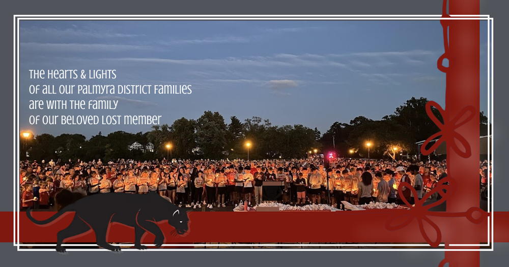 crowd holding candles in a vigil as the sun sets in palmyra harbour