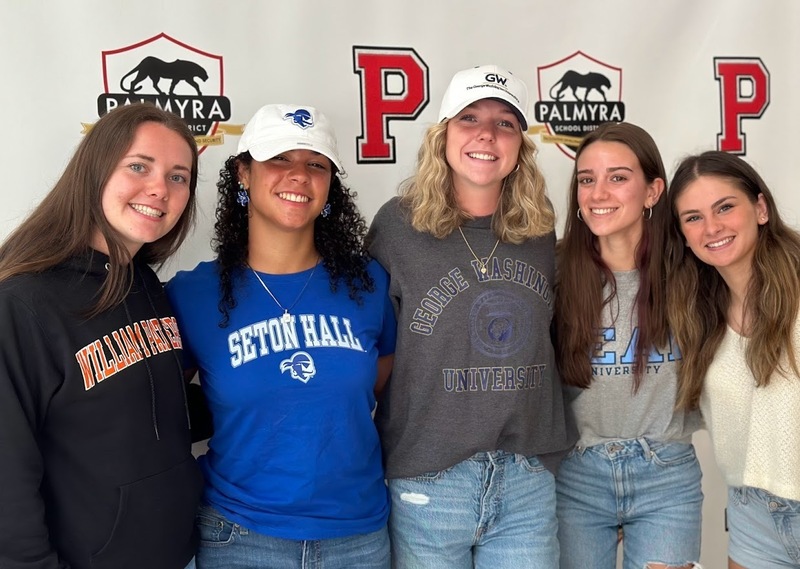 5 high school friends wearing shirts of their different college choices