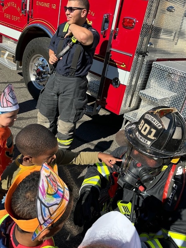preschoolers are able to get up close to a firefighter in full fire gear