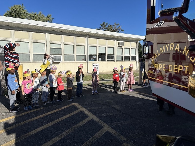 students in front of a fire truck for safety assembly