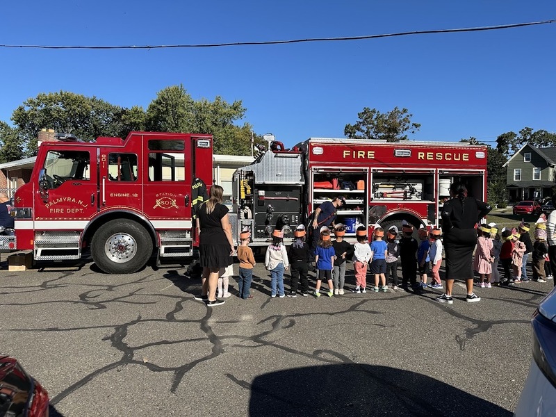 students in front of a fire truck for safety assembly