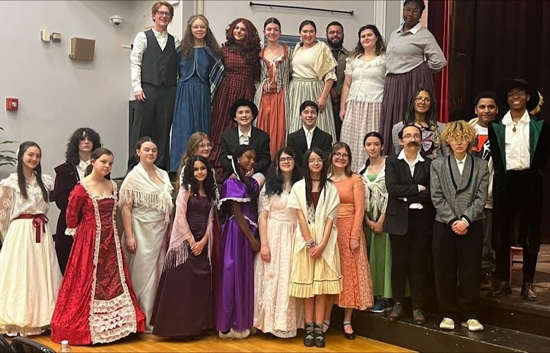 Little Women cast photo in costume in auditorium