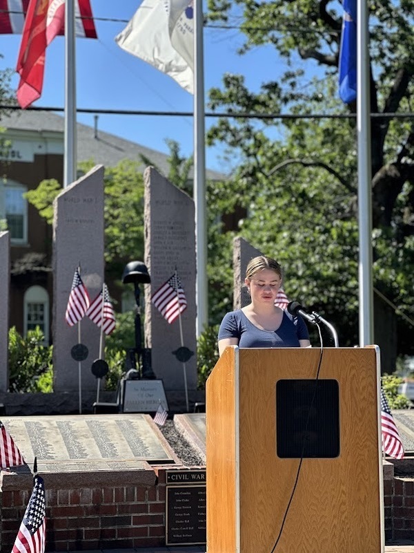 Lila Hemmons reads her essay to those assembled for Memorial Day at the War Memorial