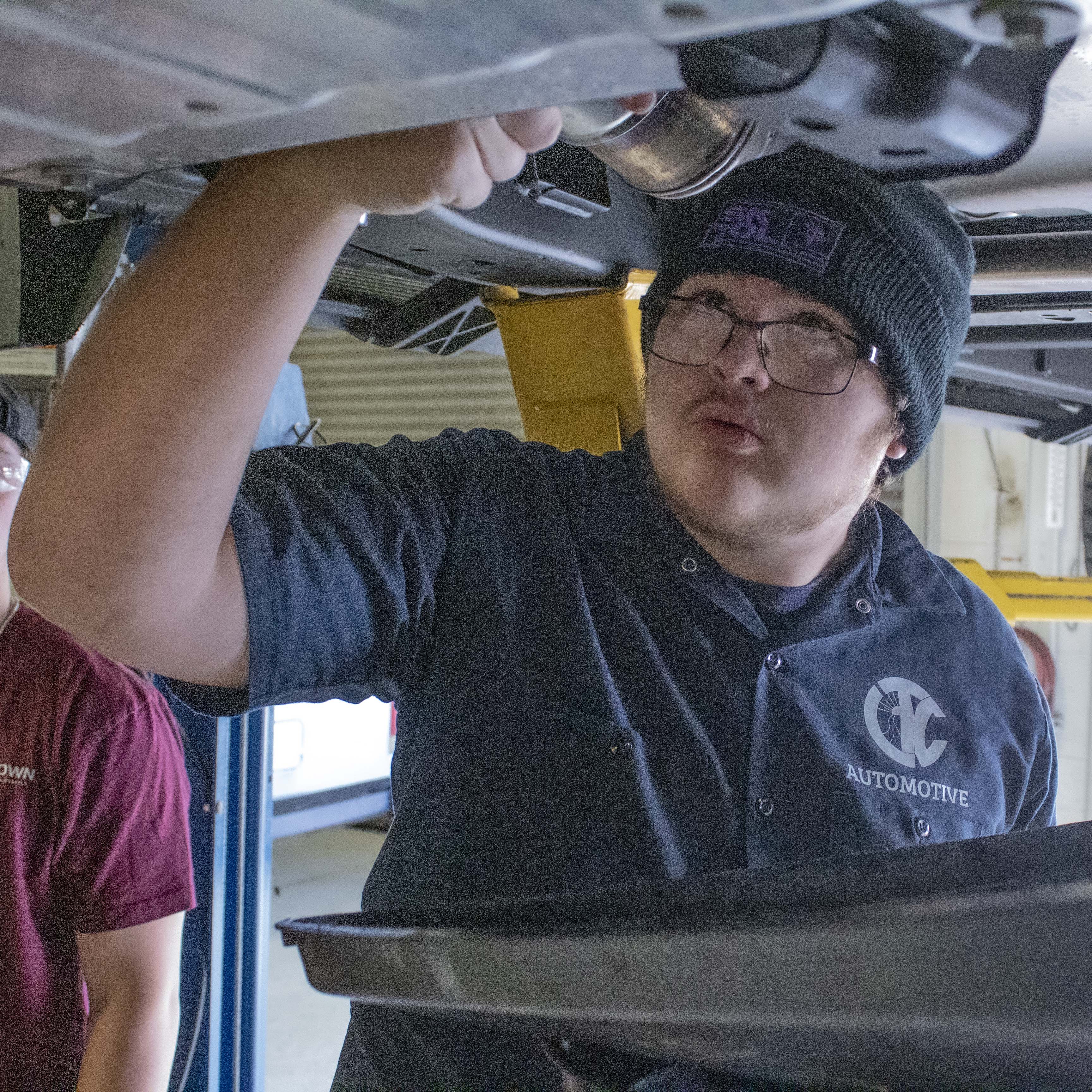 student working on car in auto shop at CTC