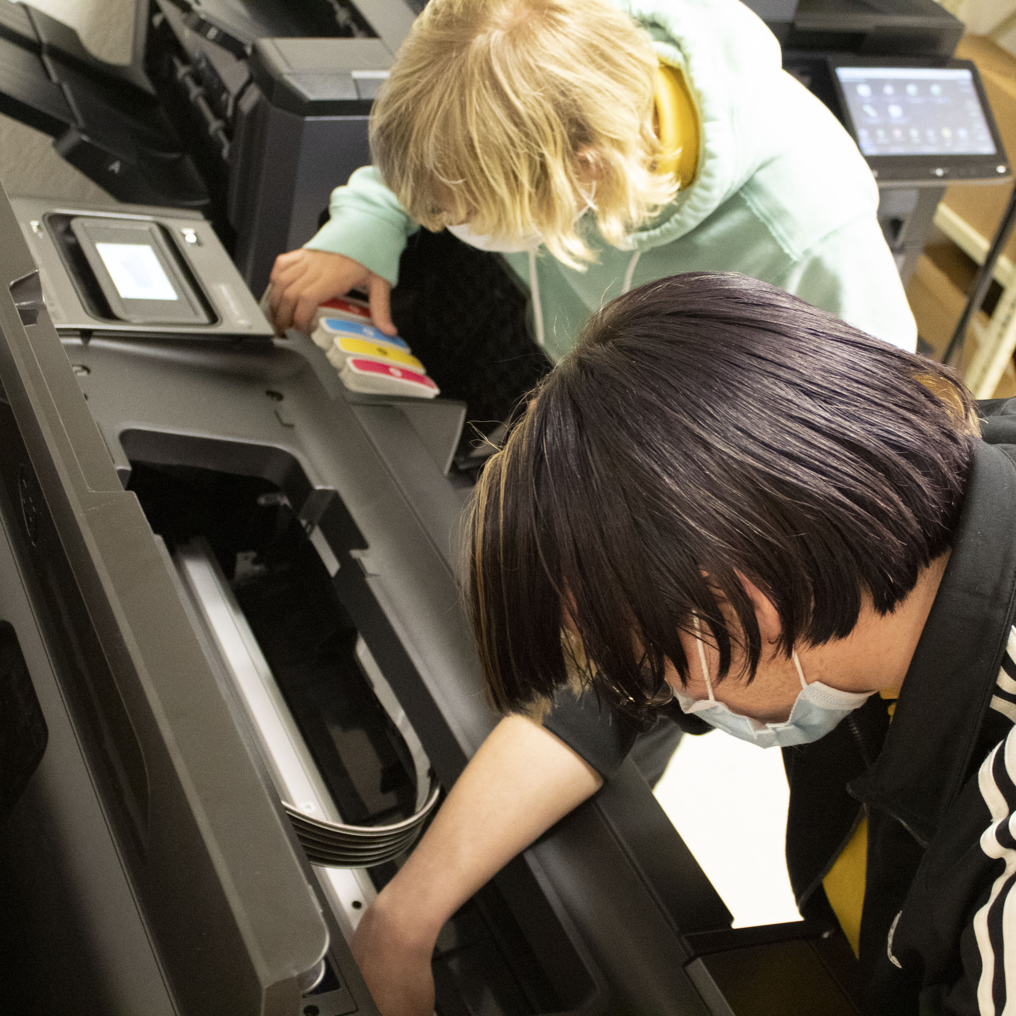 students working on a large format printer