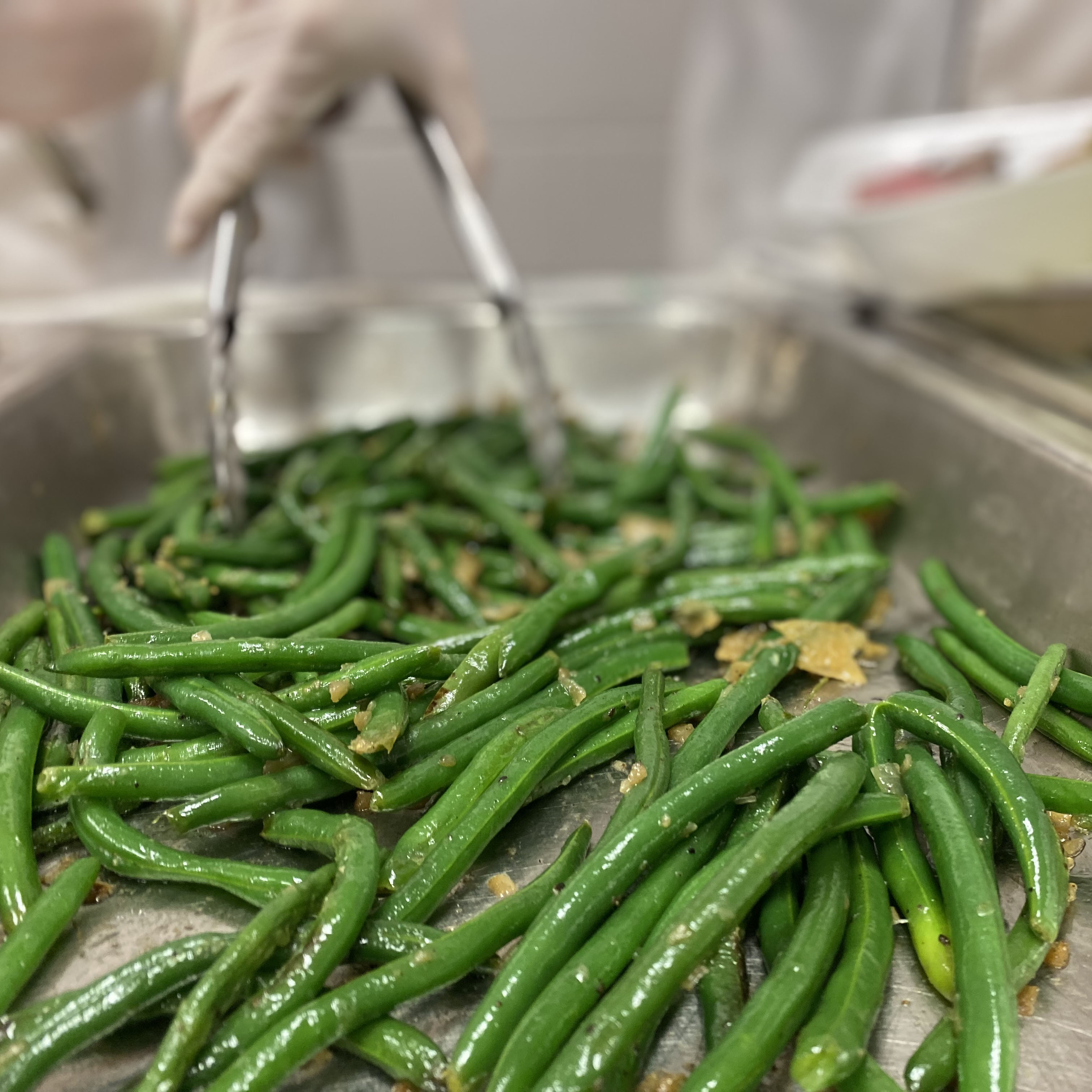 student serving green beans in Papa G's at CTC