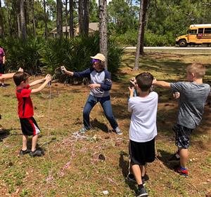 Ms. Johnston rewarding students with silly string for LiveSchool.