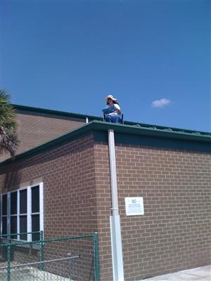 Ms. Davis reading on the roof as a reward for students. 