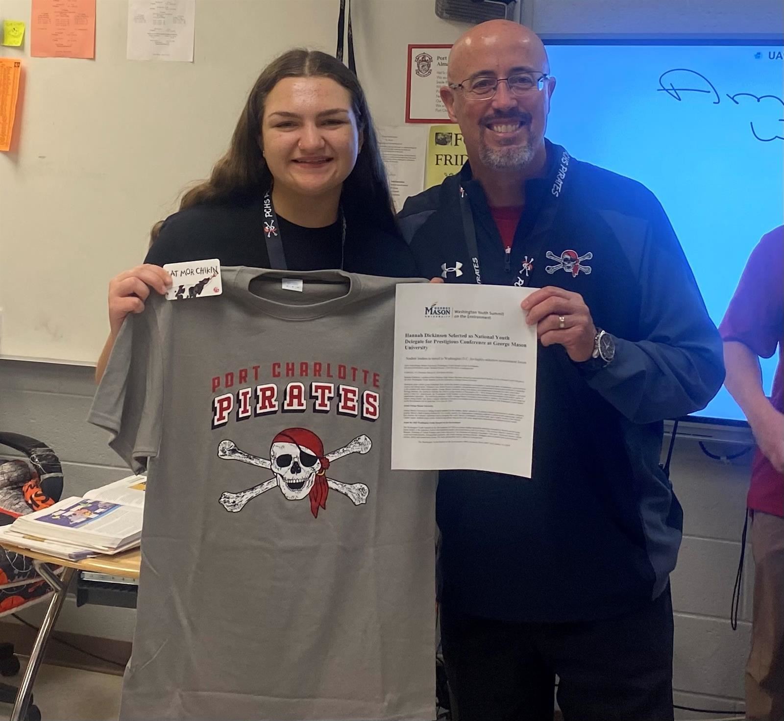   Photo of Hannah Dickinson with School principal holding press release and celebrating 